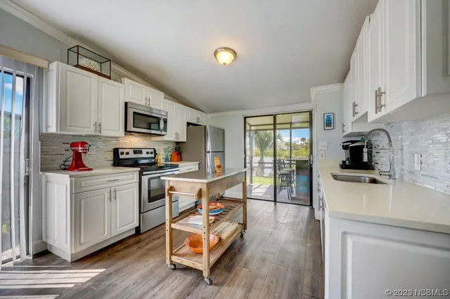 a kitchen with a stove a sink and a refrigerator