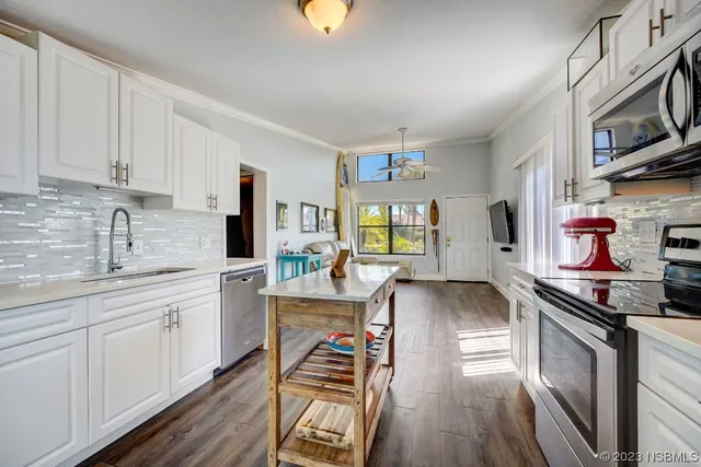 a kitchen with stainless steel appliances granite countertop a stove and cabinets