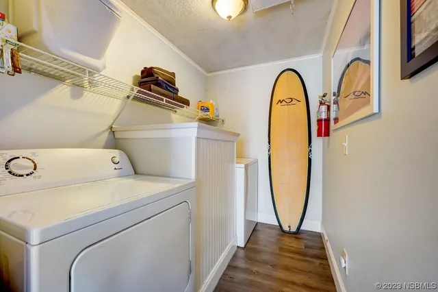 a view of walk in closet with washer and dryer