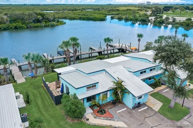 an aerial view of a house with outdoor space and lake view