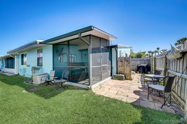 a view of a house with a garden and plants