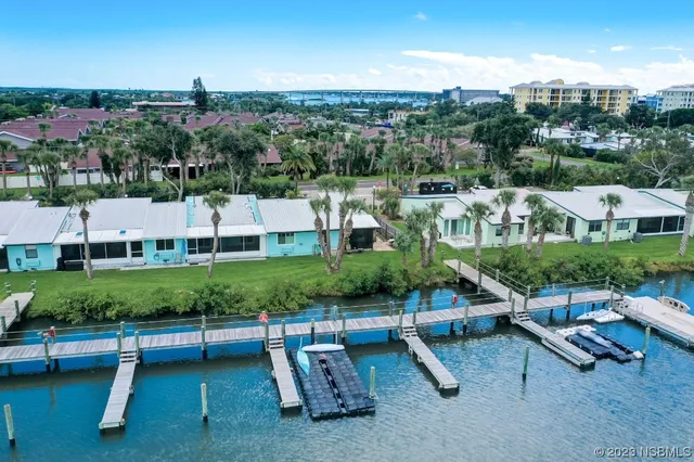 an aerial view of a house with outdoor space swimming pool and lake view