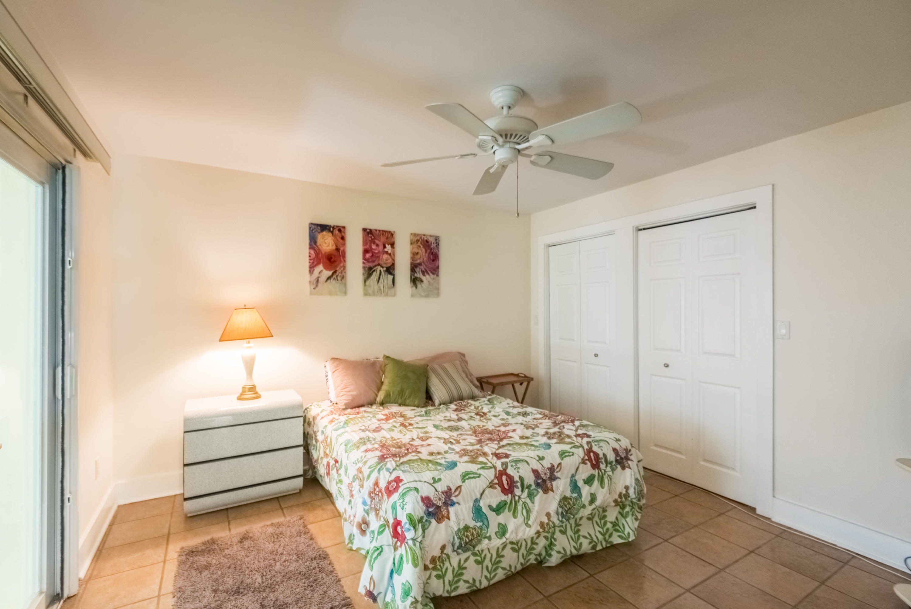 702 Florida Street Key West, FL 33040 - Photo 12 of 16 a bedroom with a bed and a chandelier