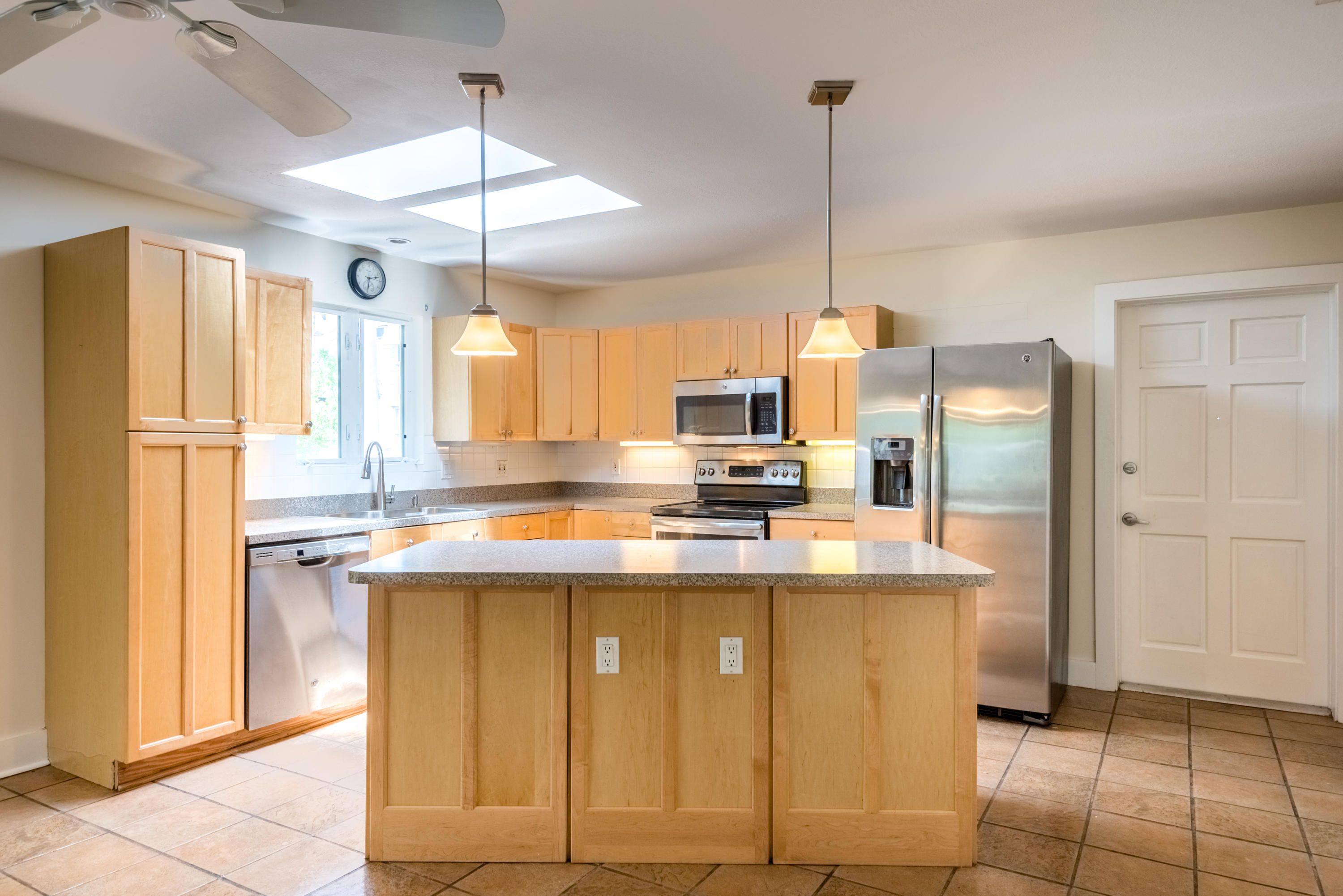 702 Florida Street Key West, FL 33040 - Photo 5 of 16 a kitchen with kitchen island a counter top space appliances and cabinets