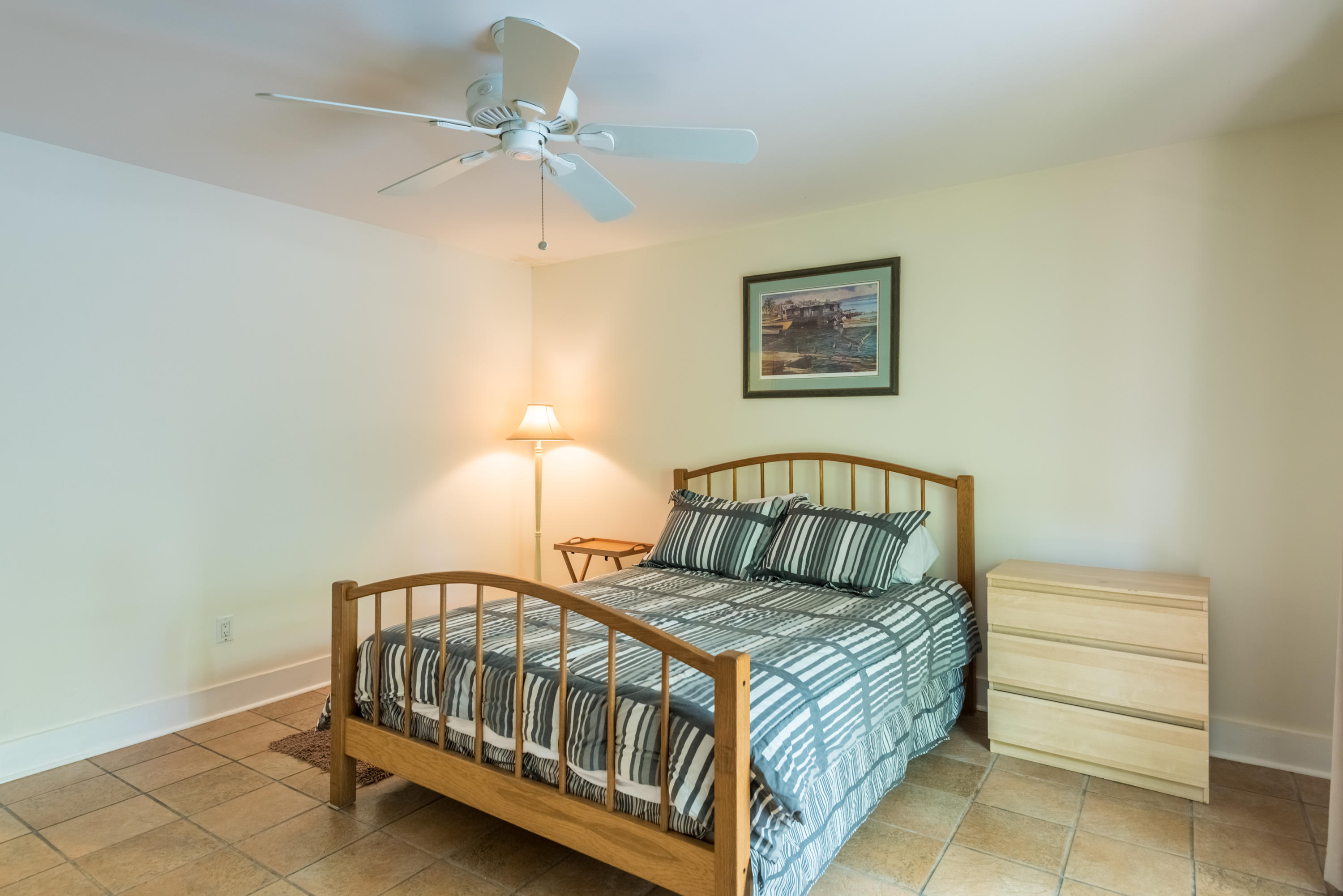 702 Florida Street Key West, FL 33040 - Photo 7 of 16 a bedroom with a bed and a chandelier