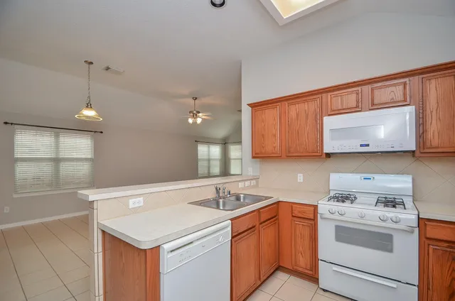 a kitchen that has a sink and a stove in it