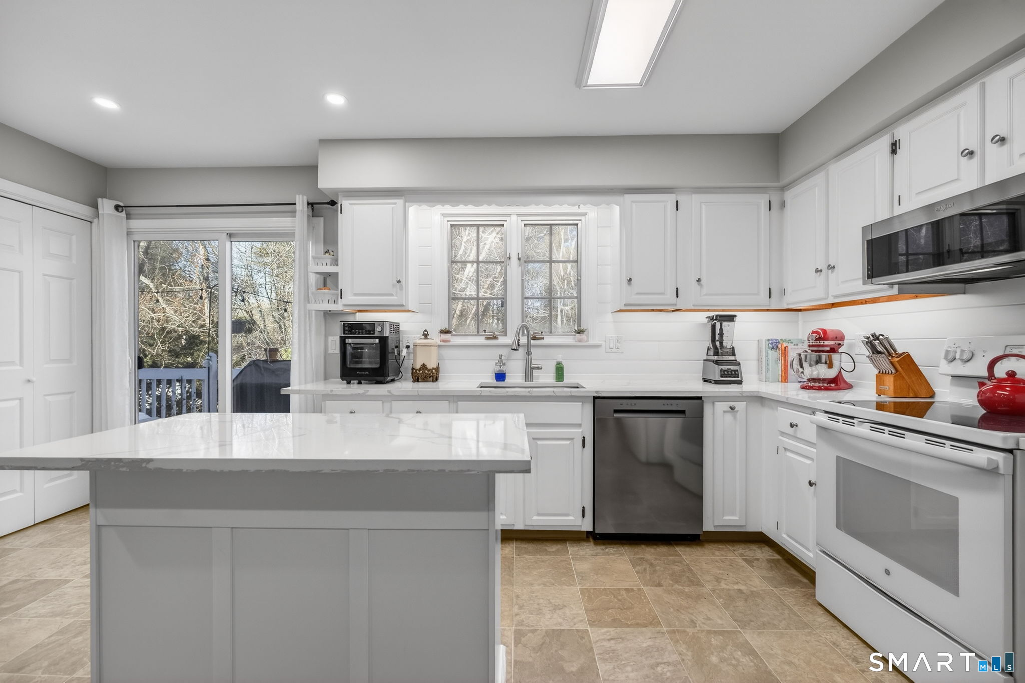 81 Founders Village, Unit 81 Clinton, CT 06413 - Photo 15 of 29 a kitchen with granite countertop white cabinets and white appliances