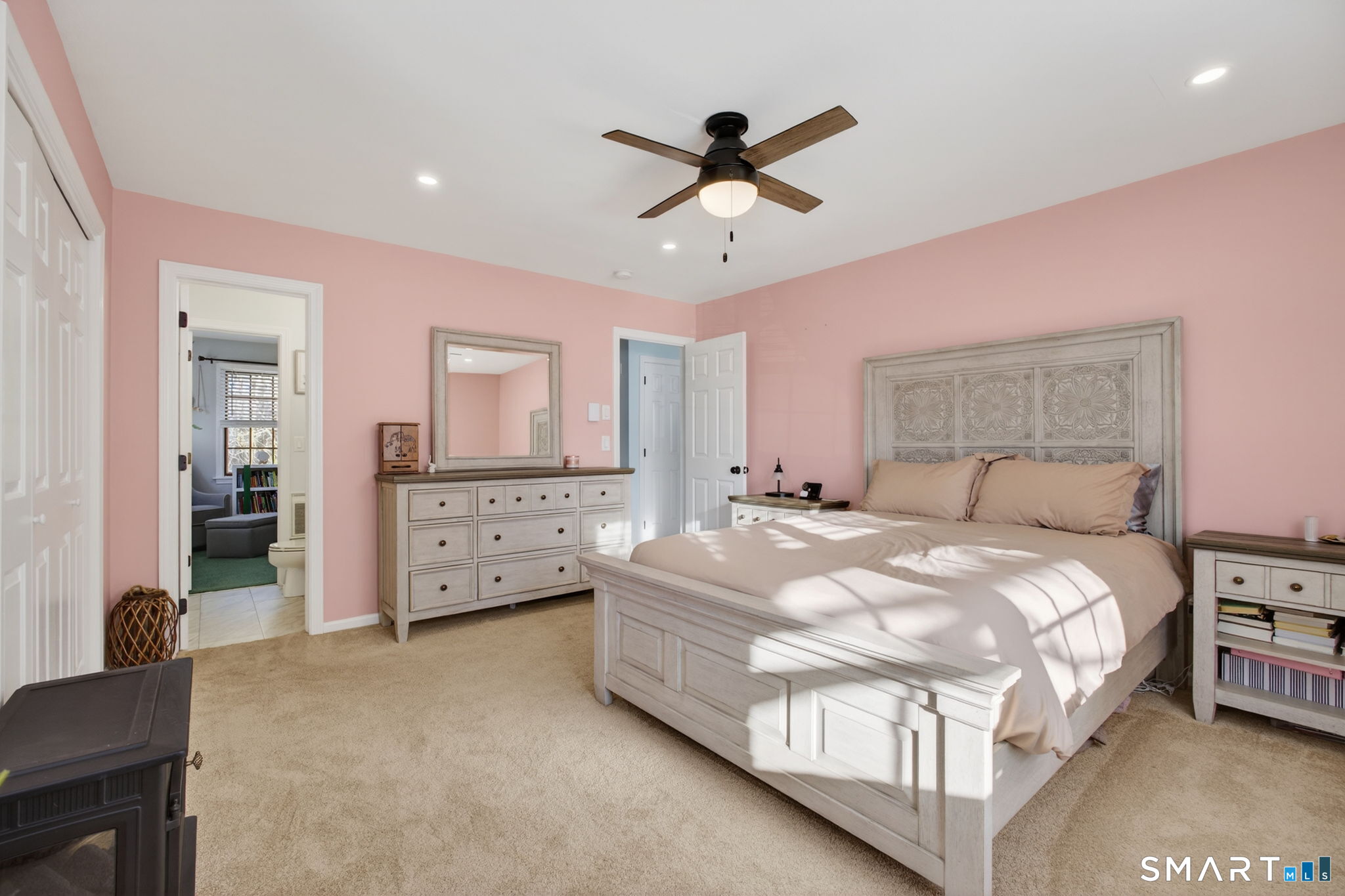 81 Founders Village, Unit 81 Clinton, CT 06413 - Photo 22 of 29 a bedroom with a bed and a chandelier