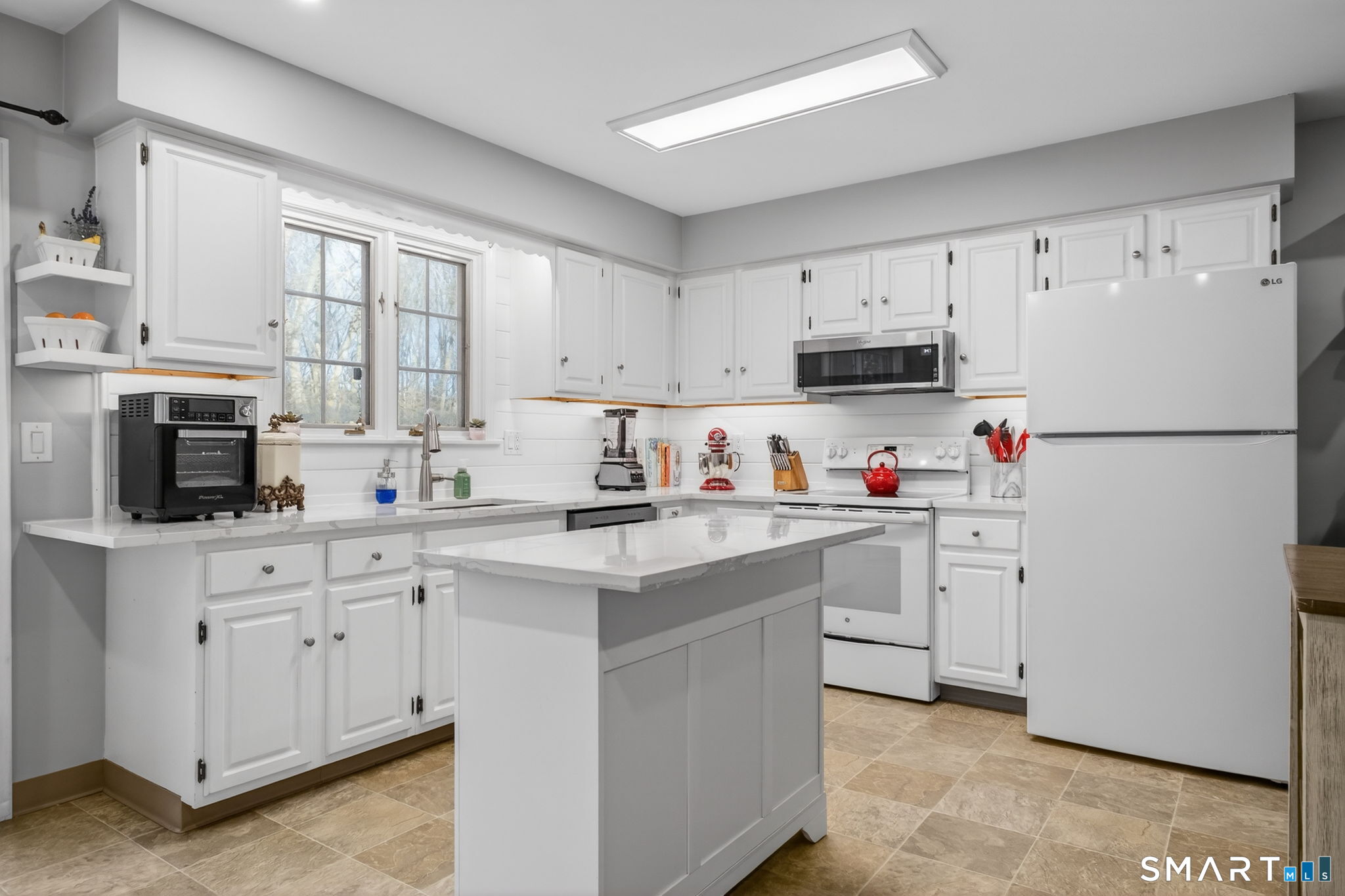 81 Founders Village, Unit 81 Clinton, CT 06413 - Photo 9 of 29 a kitchen with cabinets appliances a sink and a window