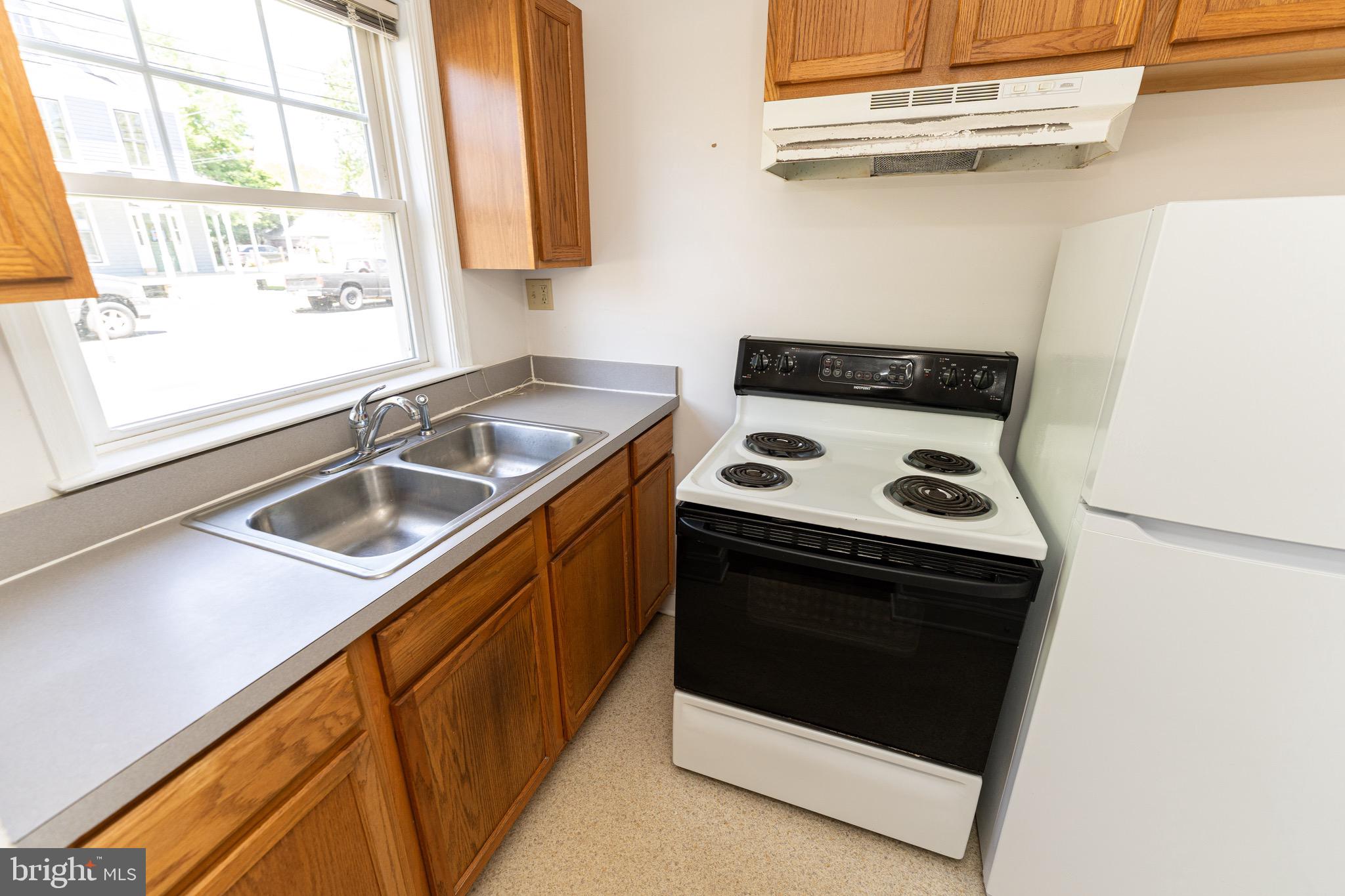 804 Travers Street, Unit 2 Cambridge, MD 21613 - Photo 10 of 26 a kitchen with a stove and a sink