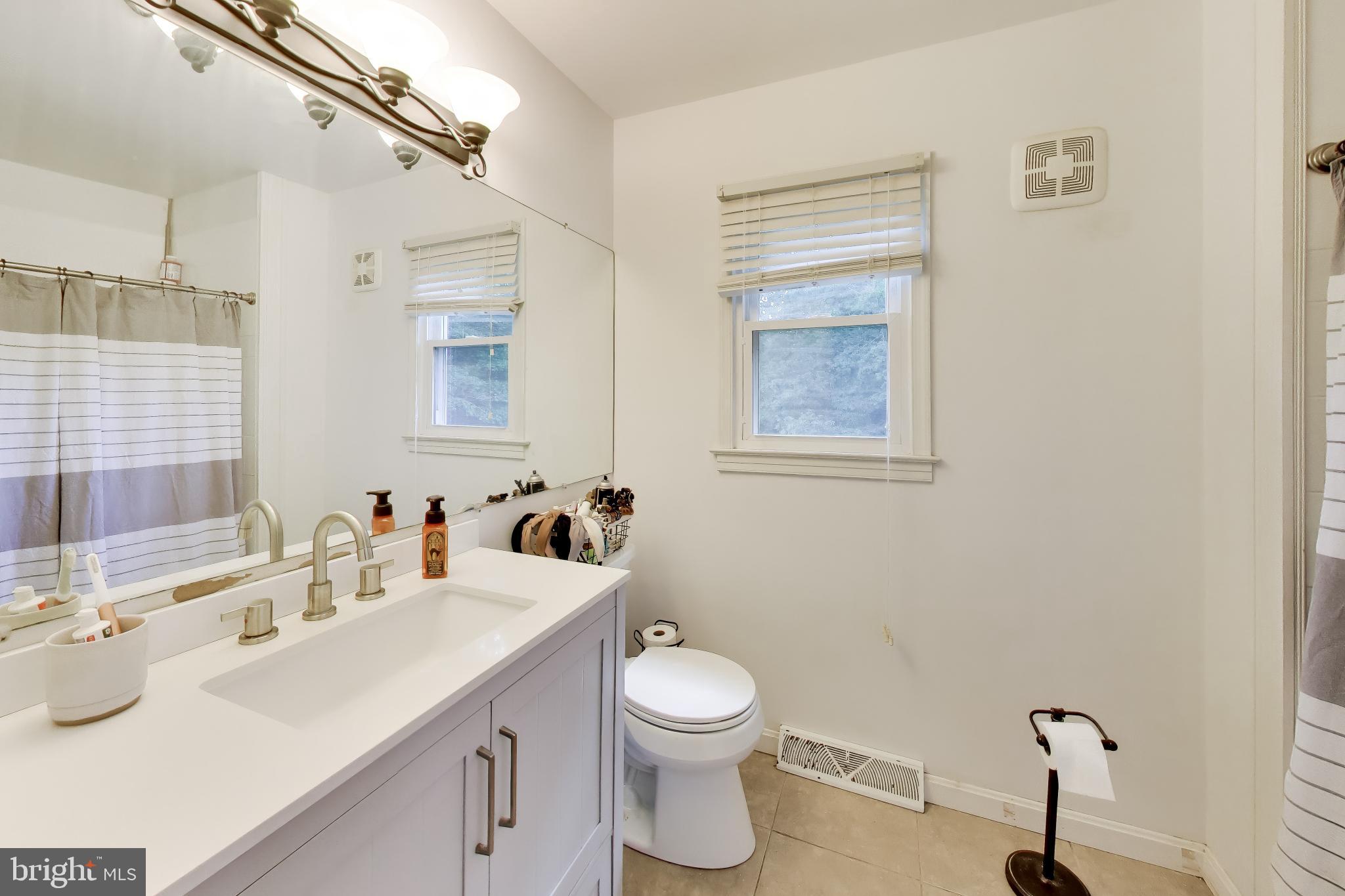 3240 Juniper Lane Huntingtown, MD 20639 - Photo 11 of 48 a bathroom with a toilet sink and mirror
