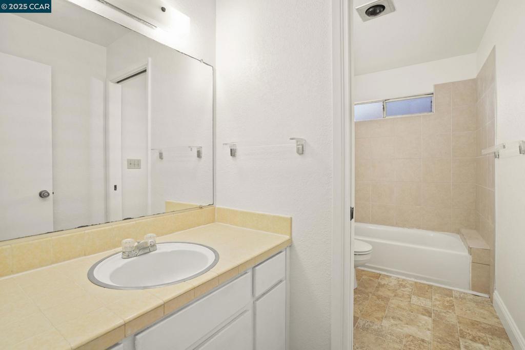 1440 Reganti Place Concord, CA 94518 - Photo 11 of 15 a bathroom with a granite countertop sink and a mirror