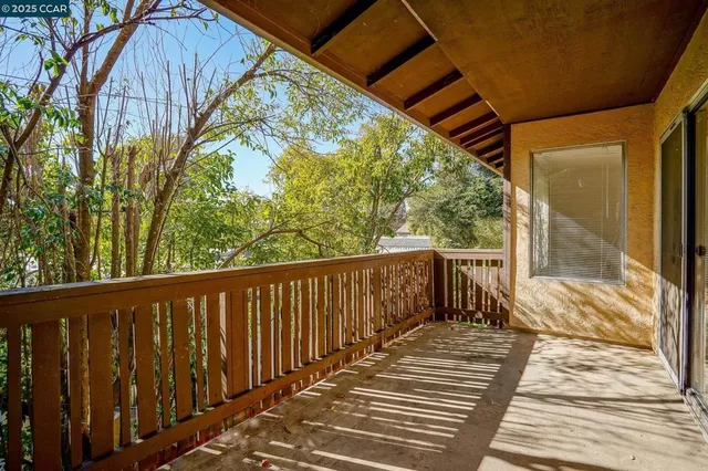 a balcony with wooden floor