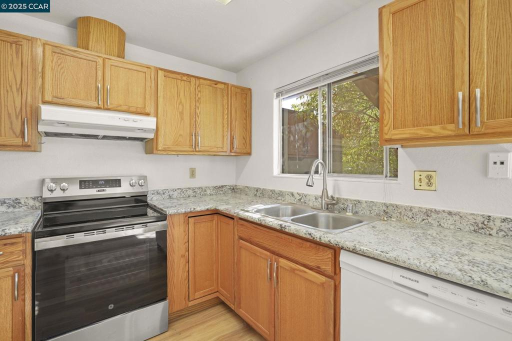 1440 Reganti Place Concord, CA 94518 - Photo 8 of 15 a kitchen with granite countertop a sink and a stove