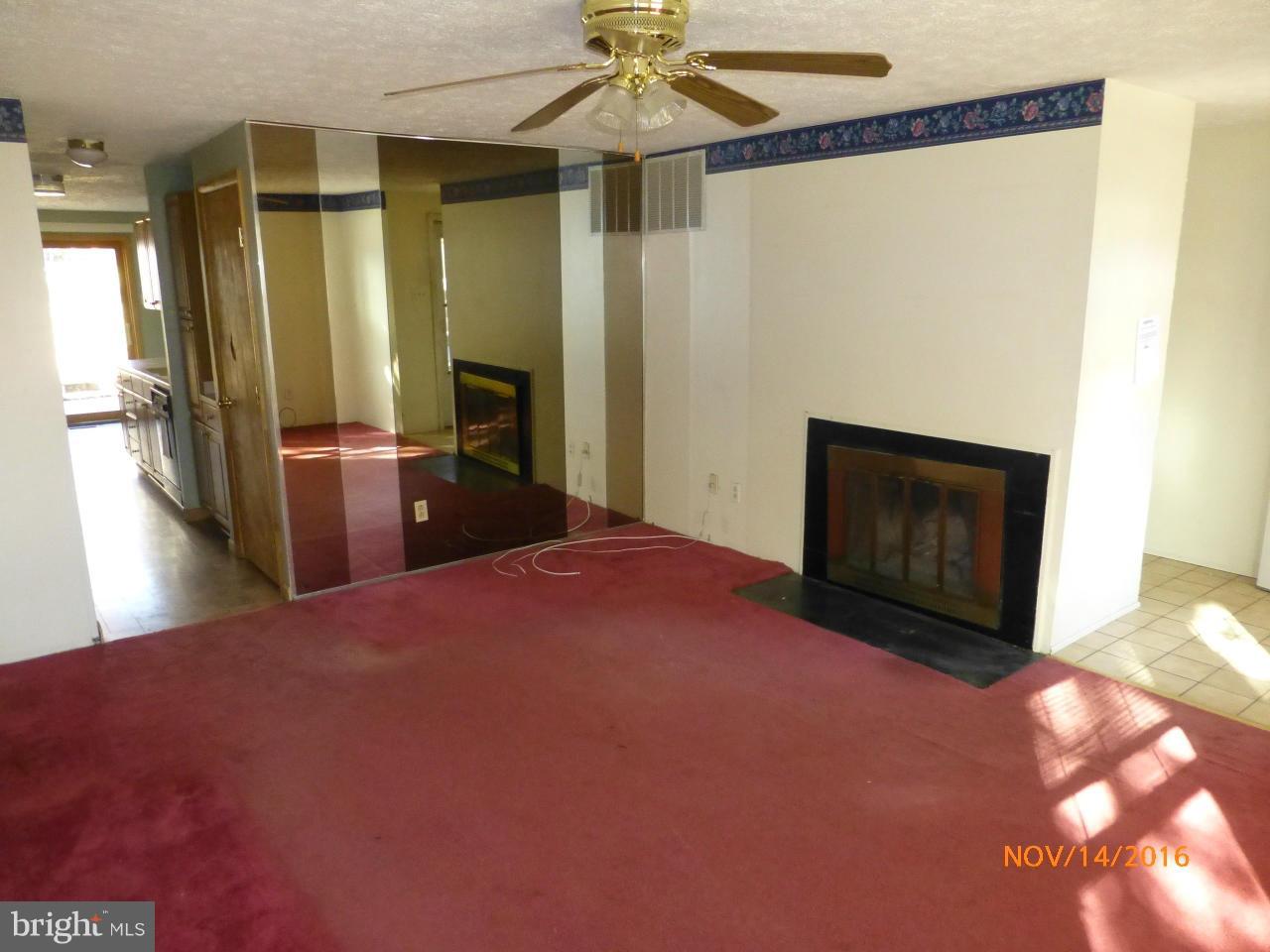 8598 Manorfield Road Baltimore, MD 21236 - Photo 3 of 16 a bedroom with a bed and a fireplace