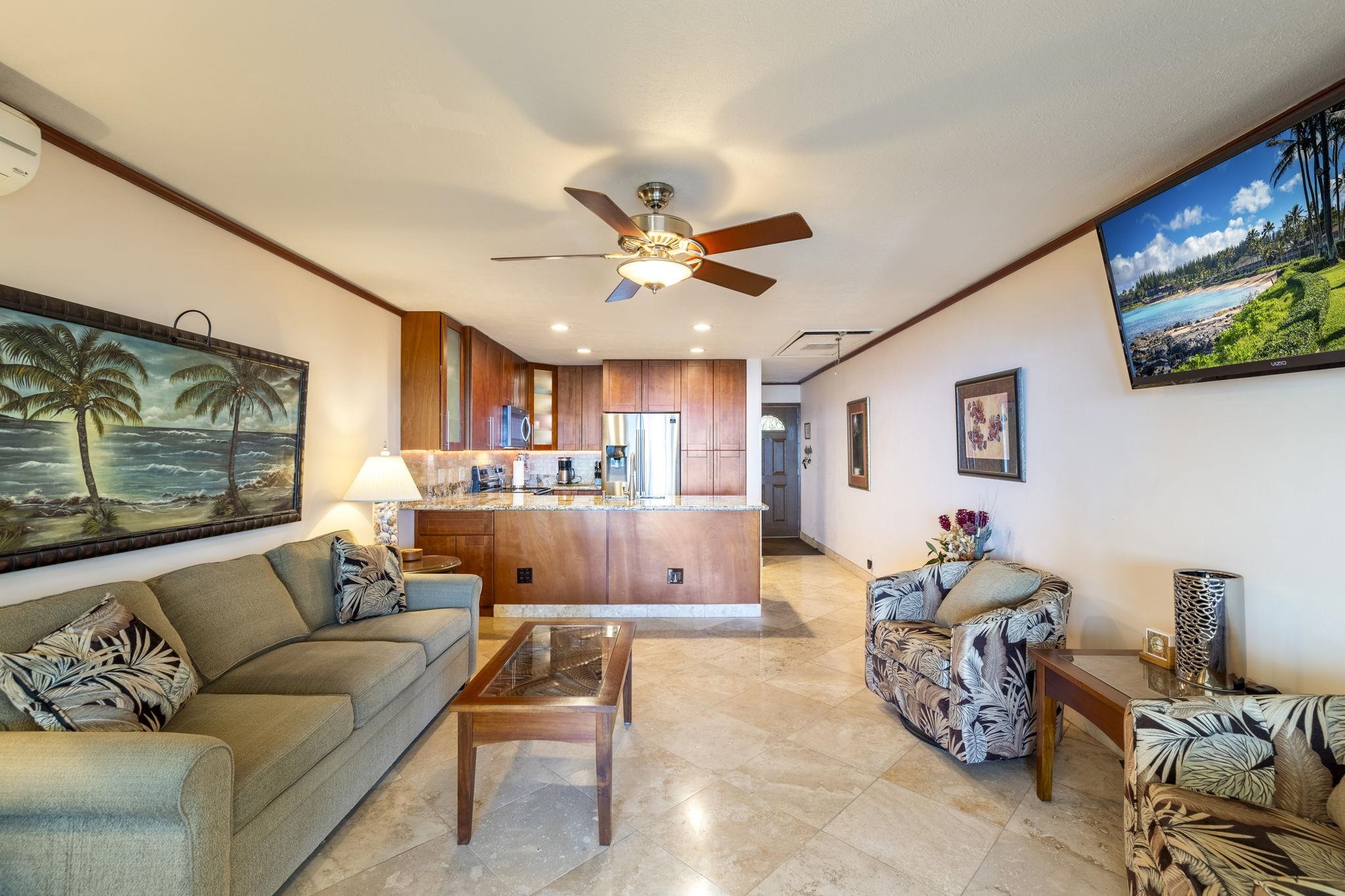 2075 South Kihei Road, Unit 214 Kihei, HI 96753 - Photo 23 of 50 a living room with furniture and a flat screen tv