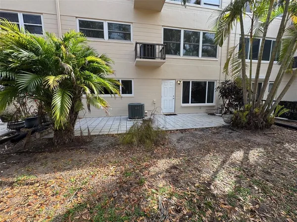 a view of a house with a yard and sitting area