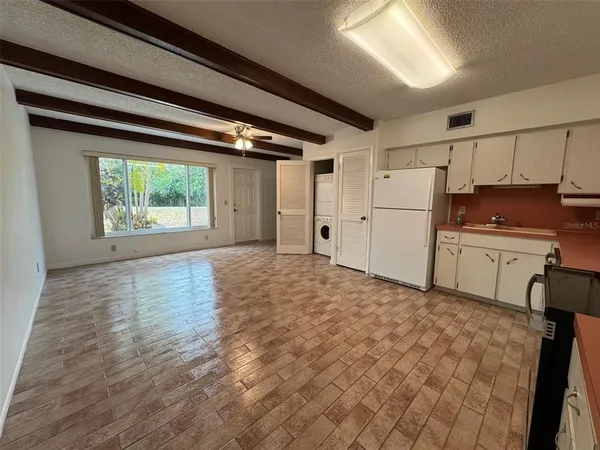 a view of a kitchen with a sink and a window