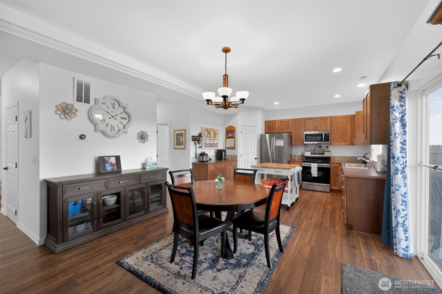 1427 West Century Street Moses Lake, WA 98837 - Photo 11 of 30 a dining room with furniture a chandelier and wooden floor