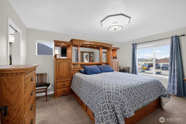 a bedroom with a bed and a dresser