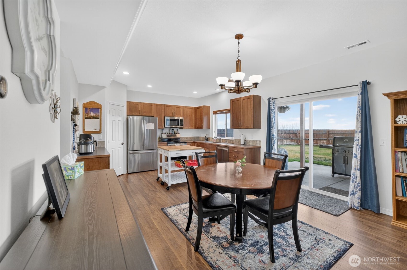 1427 West Century Street Moses Lake, WA 98837 - Photo 23 of 30 a view of a dining room with furniture wooden floor and chandelier