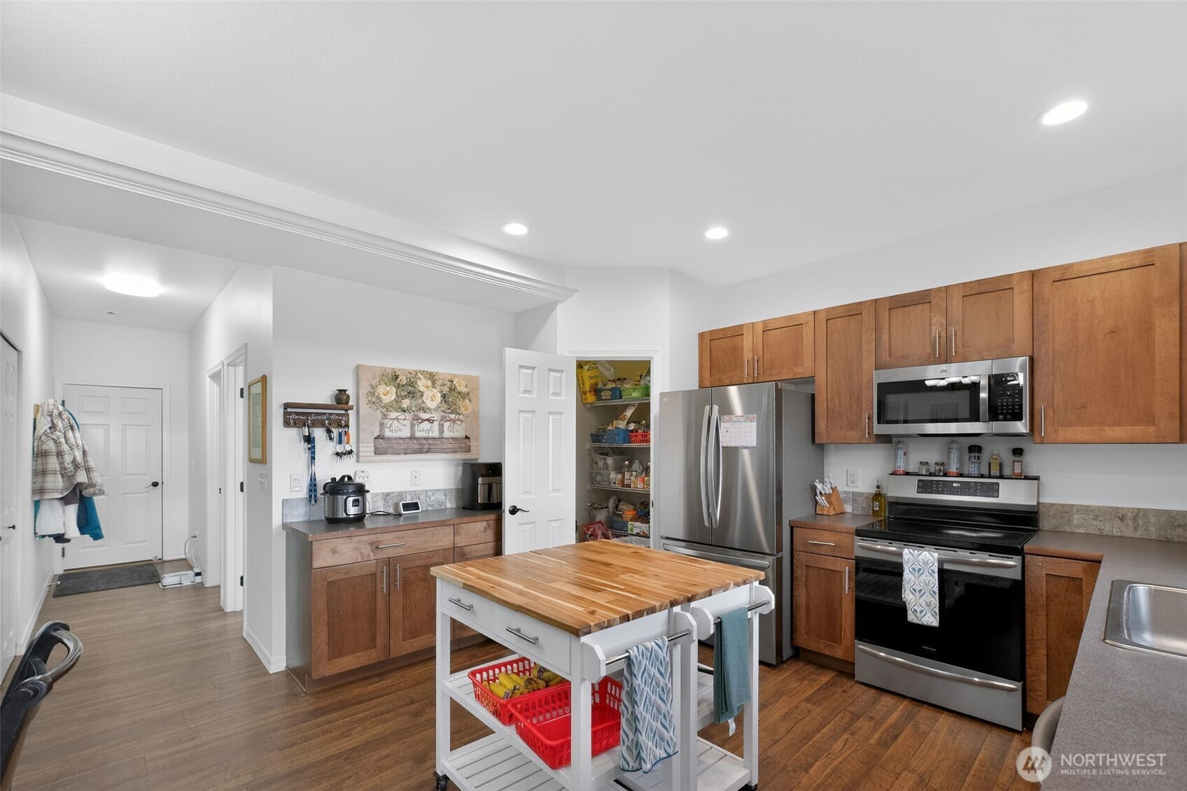 1427 West Century Street Moses Lake, WA 98837 - Photo 6 of 30 a kitchen with stainless steel appliances kitchen island granite countertop a refrigerator stove and oven
