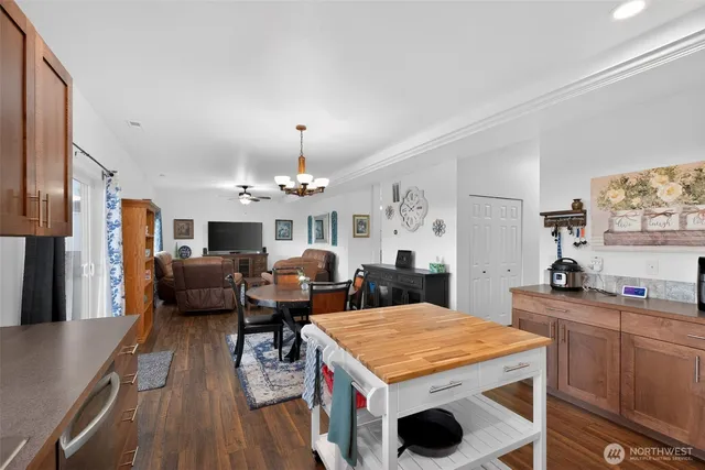 a open kitchen with stainless steel appliances granite countertop a stove refrigerator and a view of living room