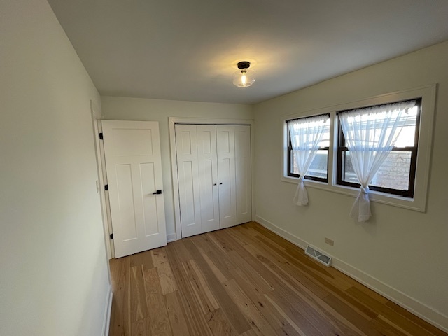 446 East 90th Street Chicago, IL 60619 - Photo 22 of 36 a view of an empty room with wooden floor and a window