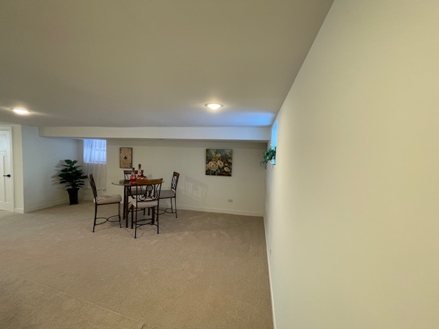 446 East 90th Street Chicago, IL 60619 - Photo 23 of 36 a view of a livingroom and a kitchen with furniture and a table