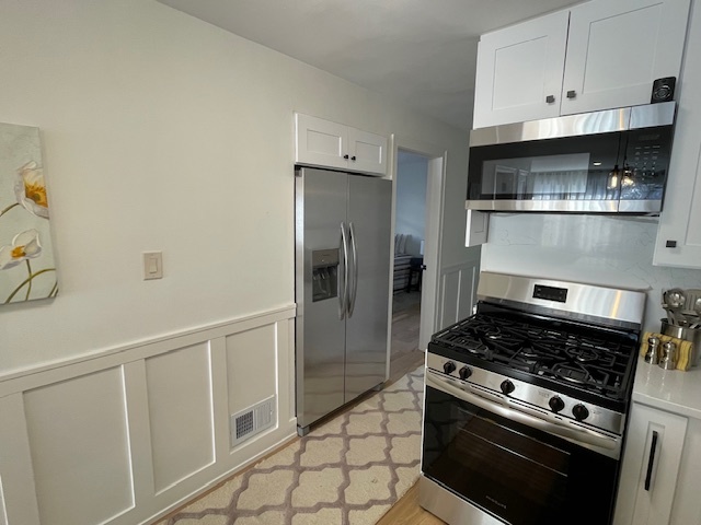 446 East 90th Street Chicago, IL 60619 - Photo 6 of 36 a kitchen with white cabinets and appliances