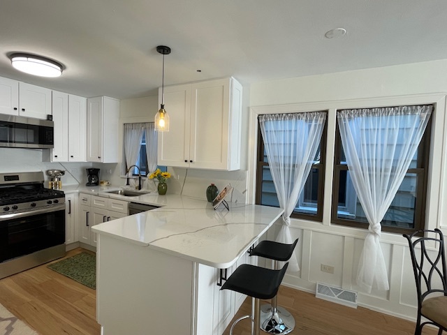 446 East 90th Street Chicago, IL 60619 - Photo 8 of 36 a kitchen with a sink a stove a refrigerator and cabinets