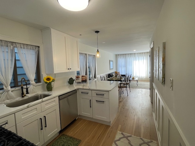 446 East 90th Street Chicago, IL 60619 - Photo 9 of 36 a large white kitchen with cabinets a sink a window and chairs