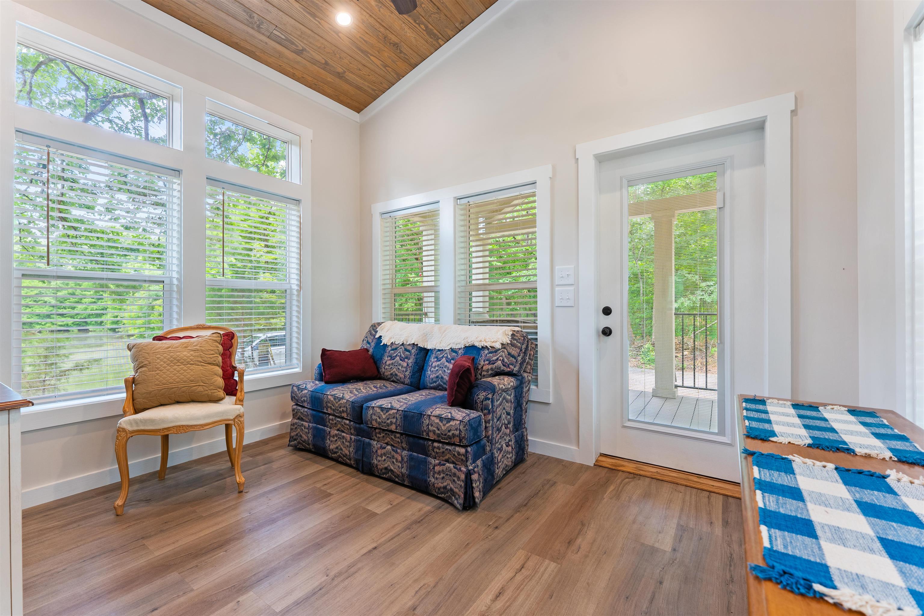 330 Whitley Road Oakland, TN 38060 - Photo 8 of 19 Vaulted wood-finish ceiling with a ceiling fan, abundant natural light through multiple windows, wood-finish flooring, and a glass-paneled exterior door