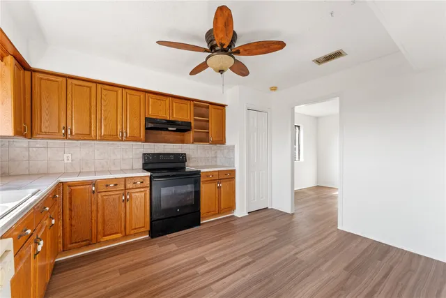 a room with a refrigerator and cabinets