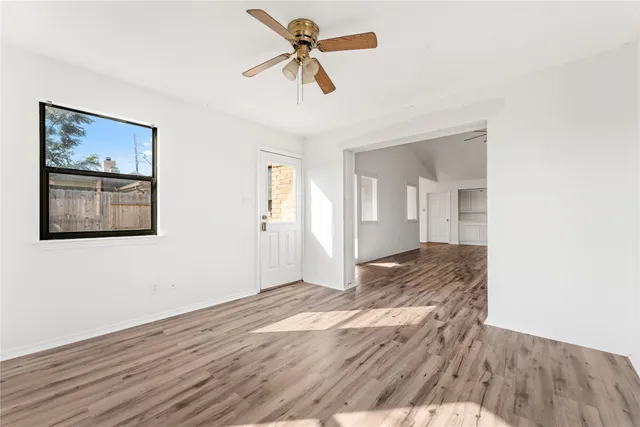 wooden floor in an empty room with a window