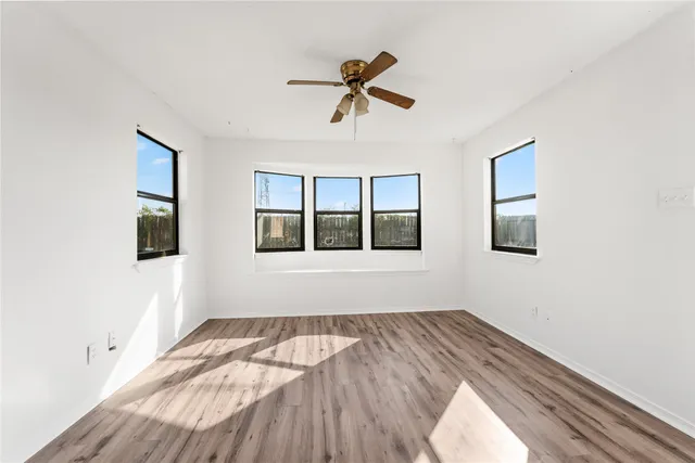 a view of room with hardwood floor and window