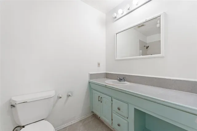 an empty room with wooden floor closet and windows