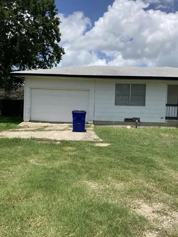 a kitchen with a refrigerator a stove a sink and a window
