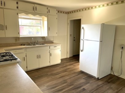 12341 Highway 21 Midway, TX 75852 - Photo 5 of 10 a kitchen with a refrigerator a stove a sink and a window