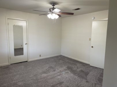 12341 Highway 21 Midway, TX 75852 - Photo 7 of 10 an empty room with a chandelier fan and a bathroom