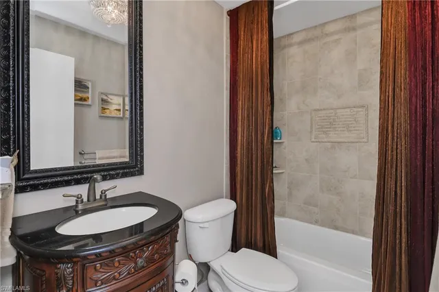 a bathroom with a sink toilet and a mirror