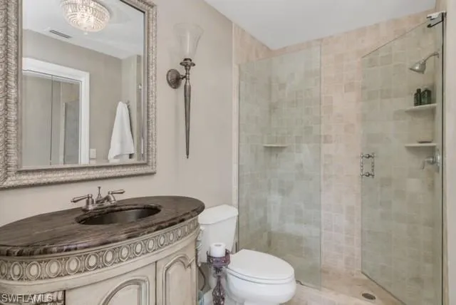 a bathroom with a sink toilet a mirror and shower