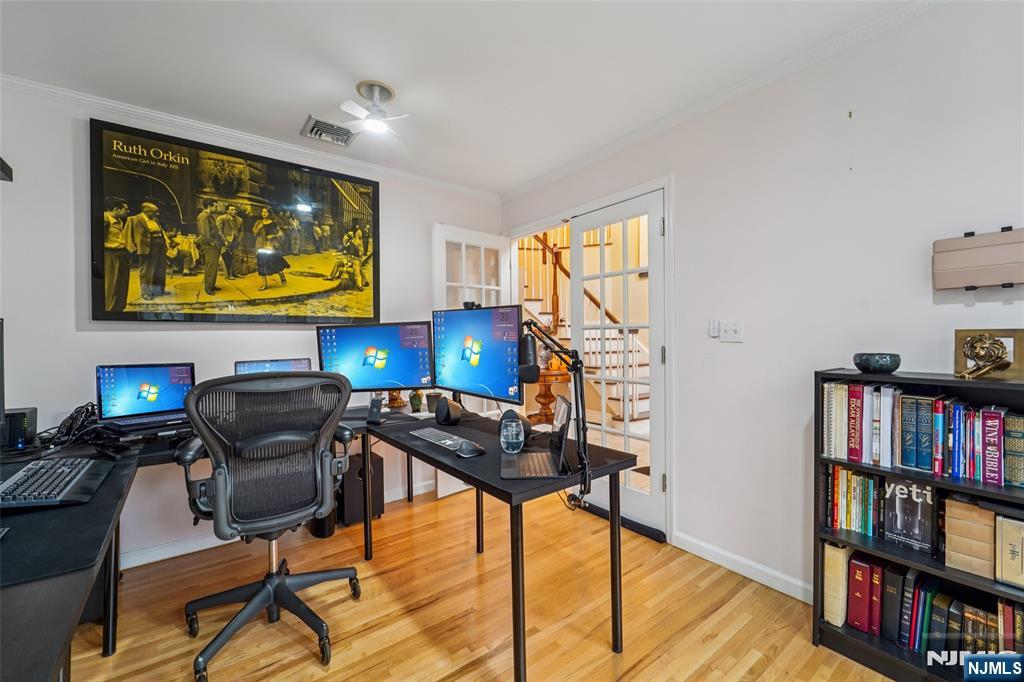 185 Summit Avenue Pompton Lakes, NJ 07442 - Photo 13 of 36 a work room with furniture a bookshelf and a flat screen tv