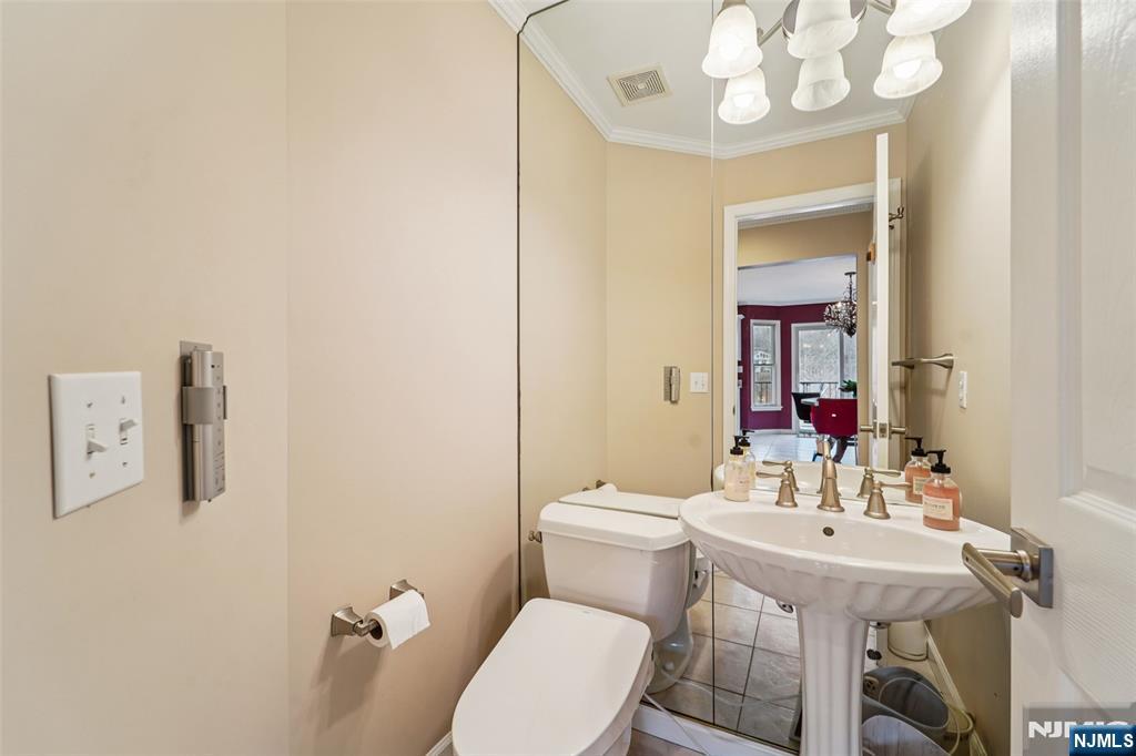 185 Summit Avenue Pompton Lakes, NJ 07442 - Photo 14 of 36 a bathroom with a sink a toilet and mirror