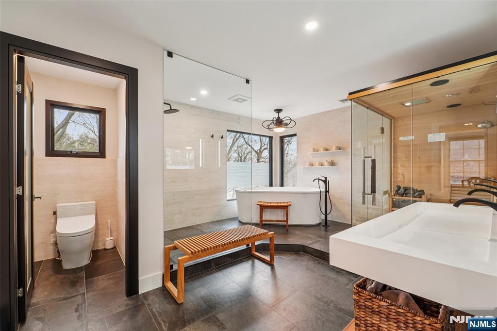 185 Summit Avenue Pompton Lakes, NJ 07442 - Photo 18 of 36 a spacious bedroom with a bed and a table chair