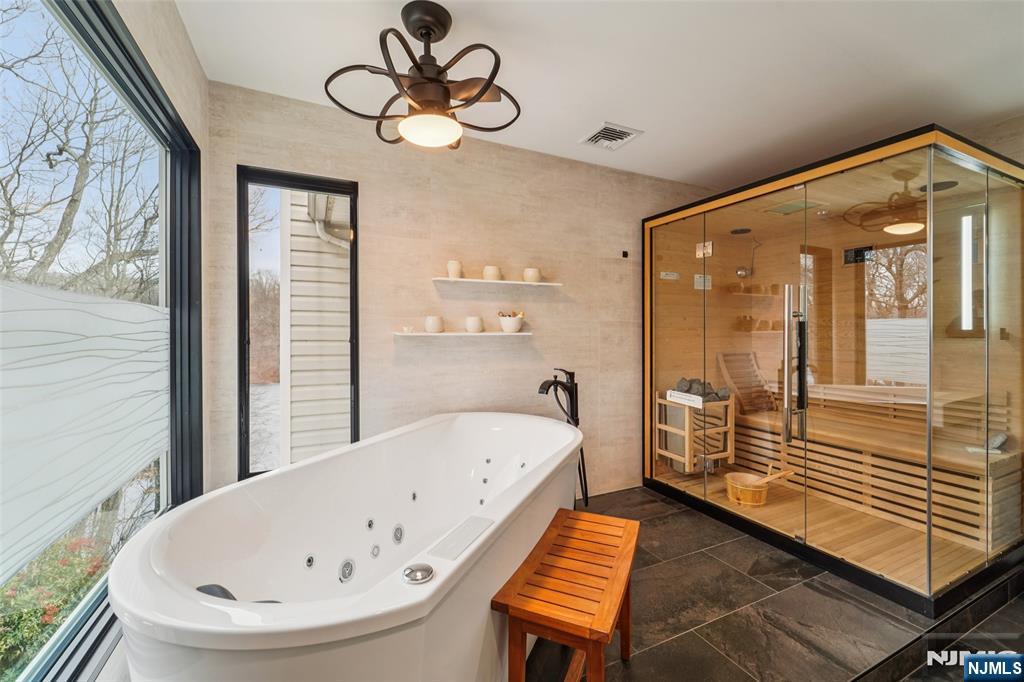 185 Summit Avenue Pompton Lakes, NJ 07442 - Photo 20 of 36 a bathroom with a bathtub and a chandelier