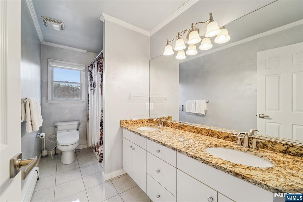 185 Summit Avenue Pompton Lakes, NJ 07442 - Photo 22 of 36 a bathroom with a granite countertop sink a toilet and a mirror