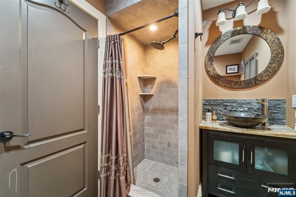 185 Summit Avenue Pompton Lakes, NJ 07442 - Photo 28 of 36 a bathroom with a sink and a mirror