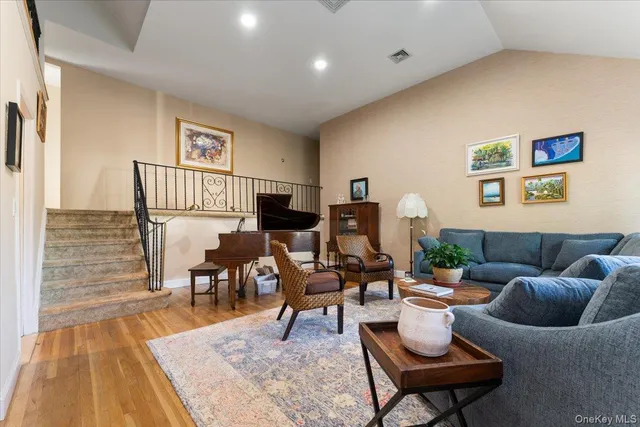a living room with furniture wooden floor and a rug