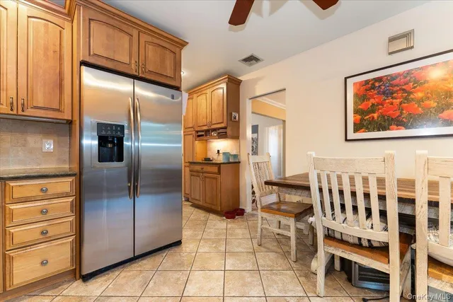 a kitchen with stainless steel appliances granite countertop a refrigerator and a stove top oven